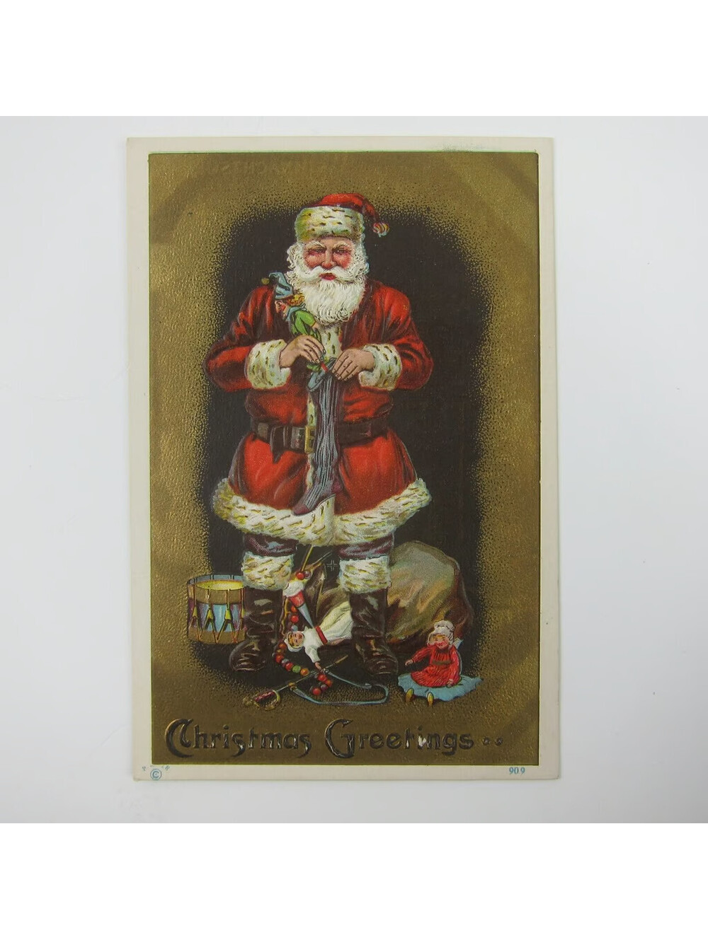 Vintage Christmas Postcard Santa Bag Toys Doll Drum Sword Gold Embossed Antique